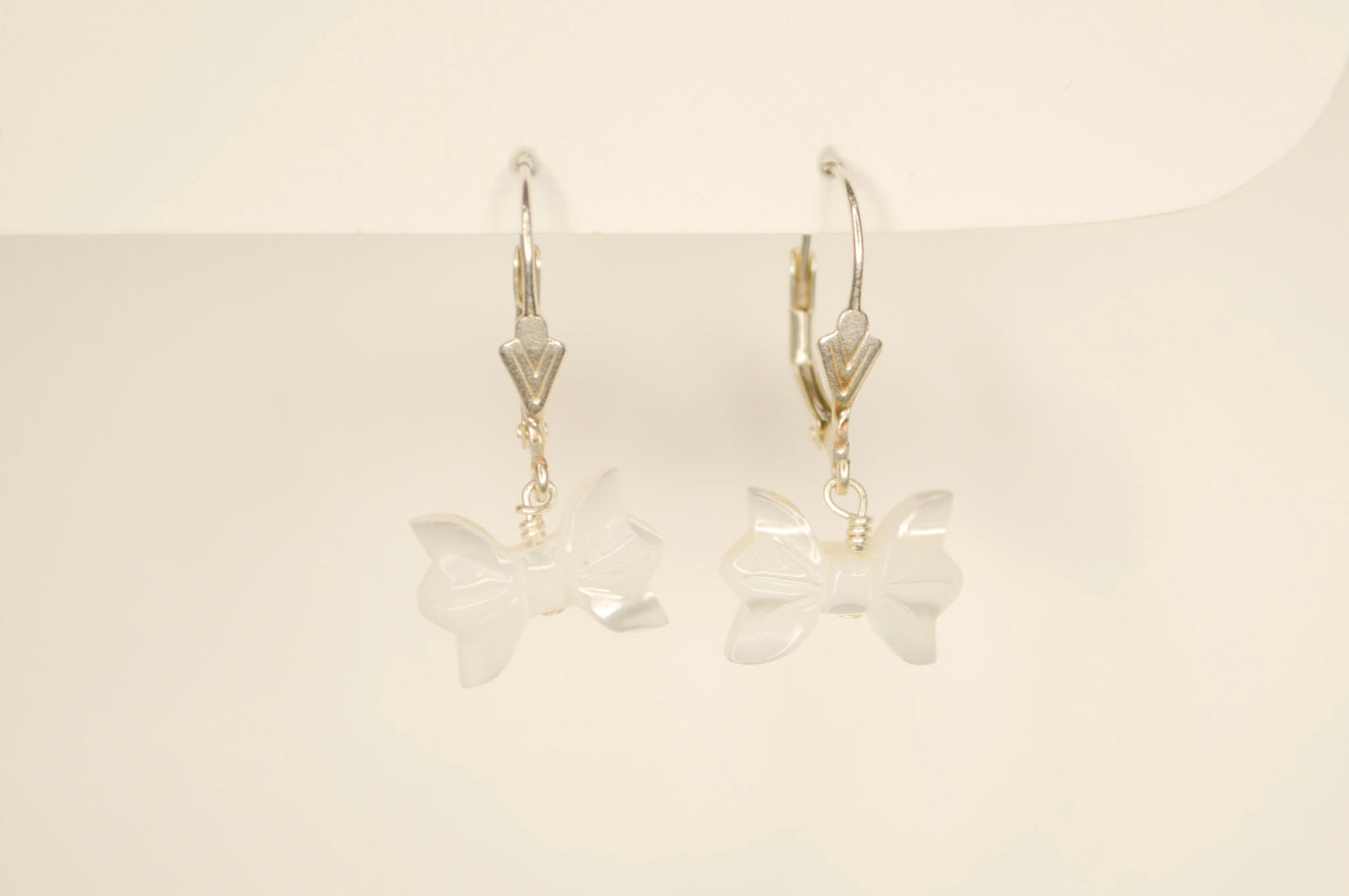 Sterling silver pearl bow hoop earrings