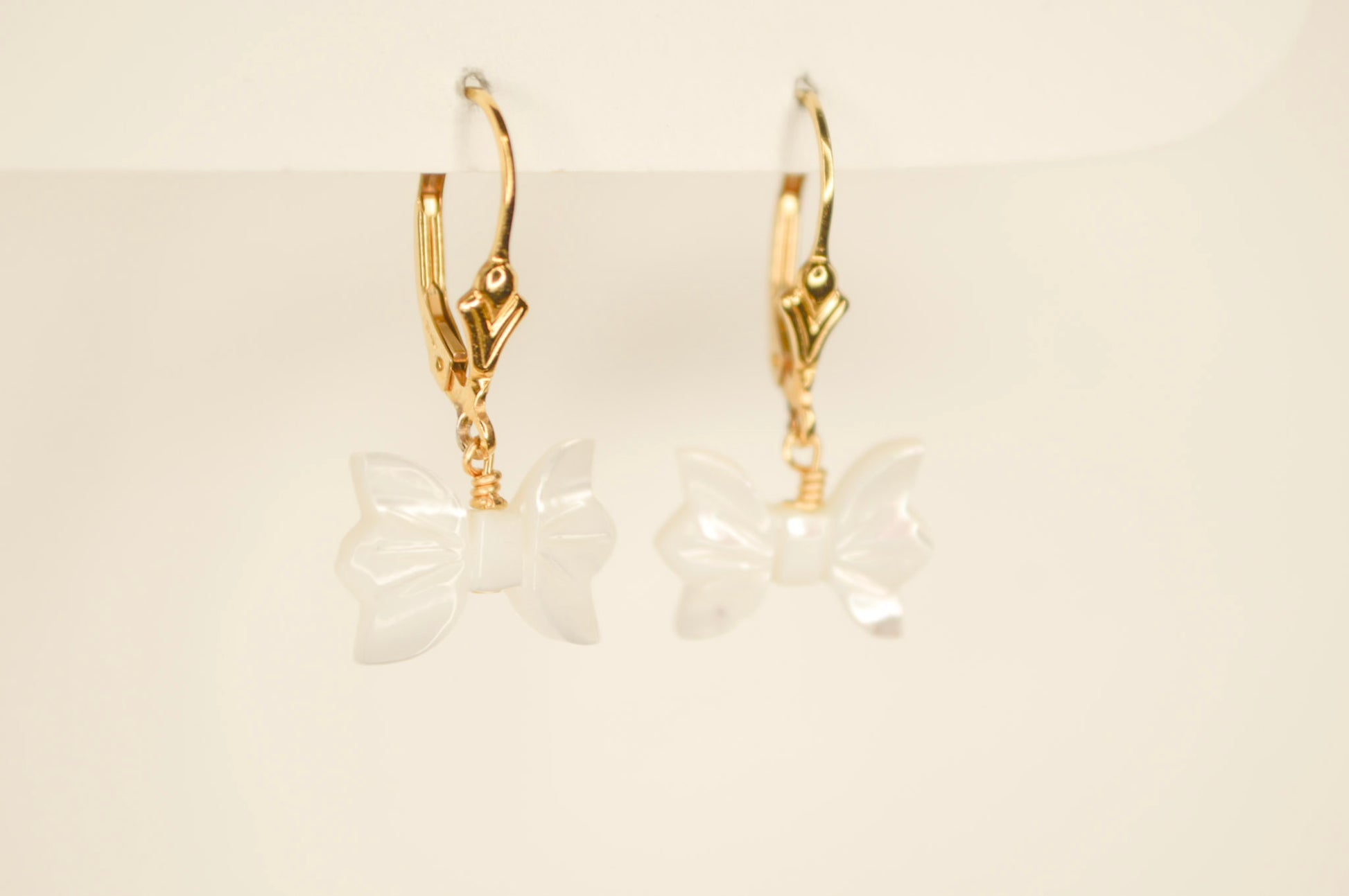 Gold freshwater pearl bow hoop earrings